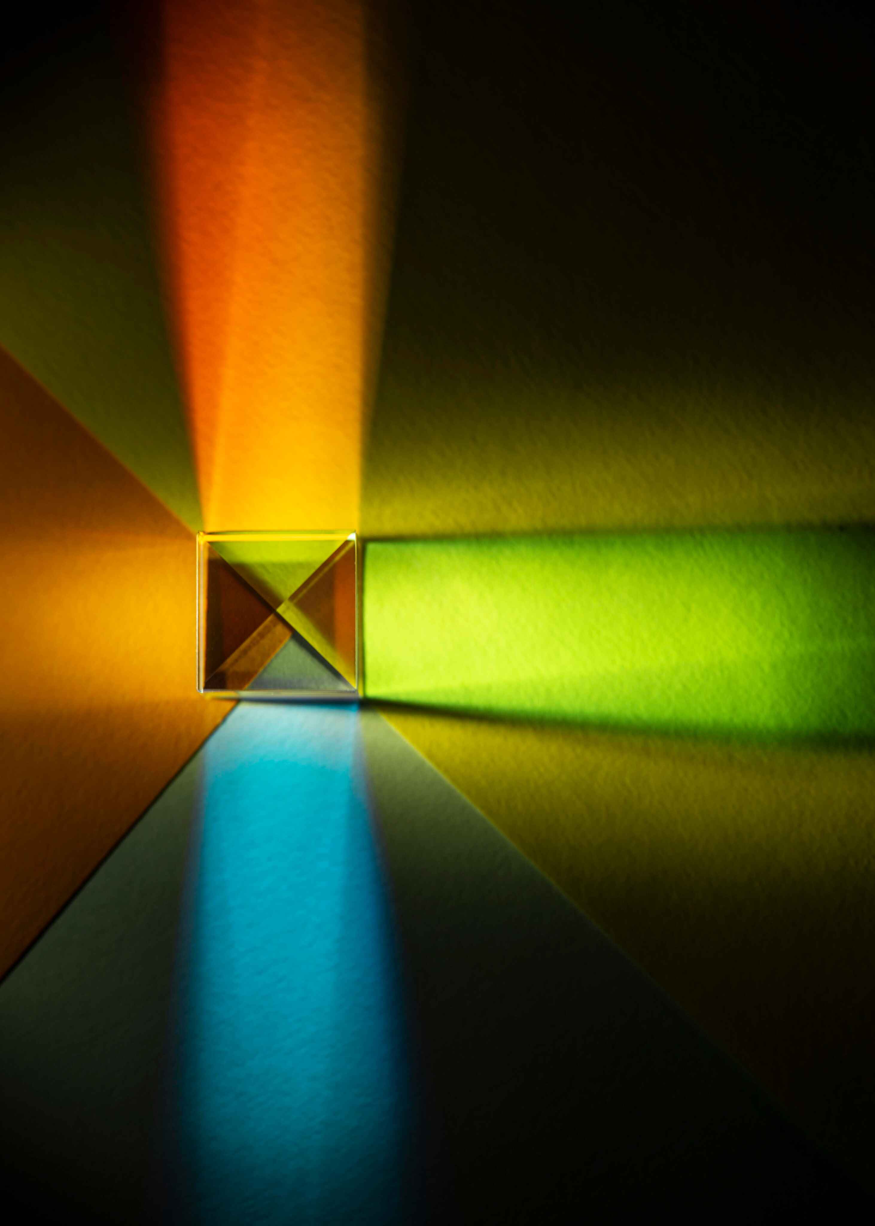 A glass prism casting vivid bands of colored light